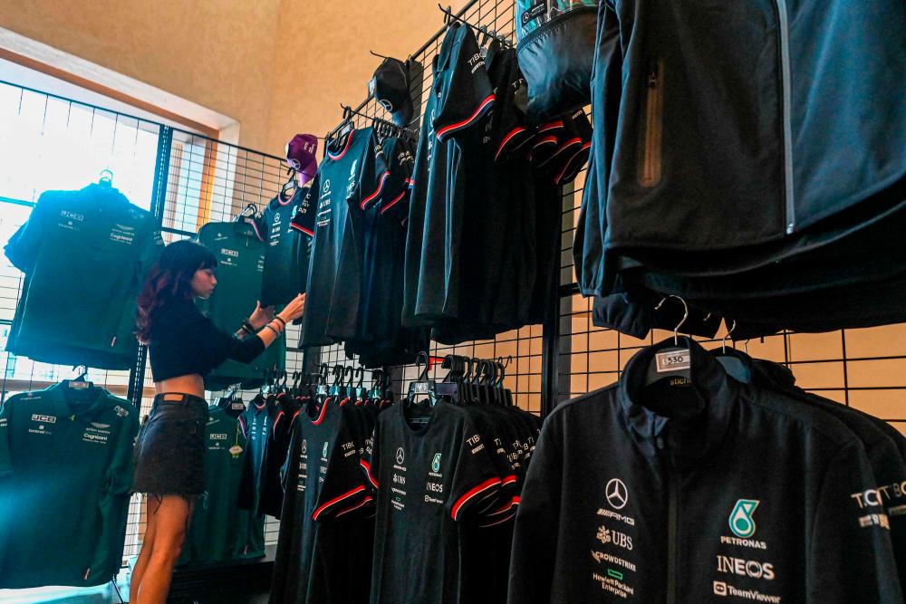 A sales promoter arranges F1 merchandise at the lobby of the Swiss Hotel for the upcoming Formula One Singapore Grand Prix night race at the Marina Bay Street Circuit in Singapore on September 27, 2022. AFPPIX