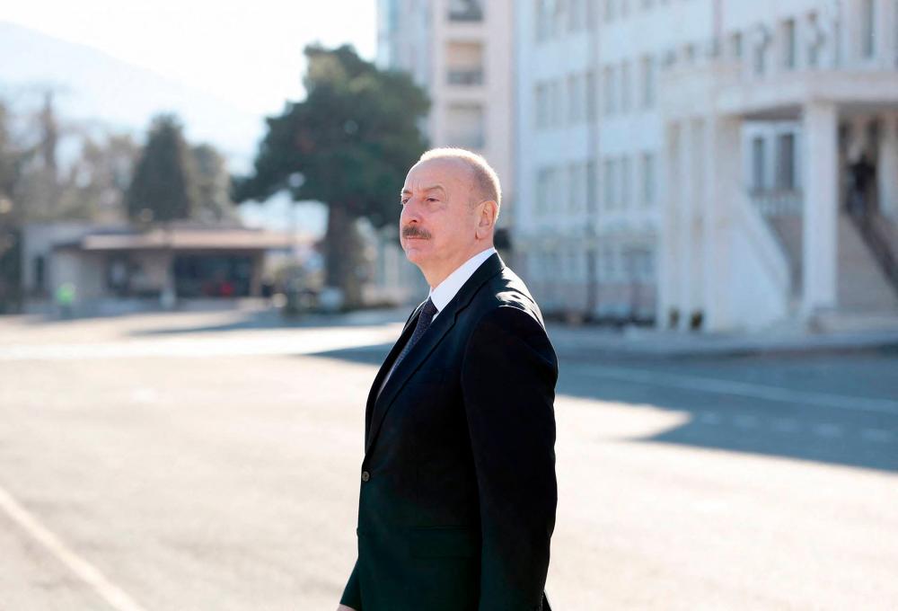 In this handout picture released by Azerbaijan’s presidency, Azeri President and presidential candidate Ilham Aliyev looks on outside a polling station after casting his ballot during Azerbaijani snap presidential election, in the city of Khankendi in the Karabakh region on February 7, 2024/AFPPix