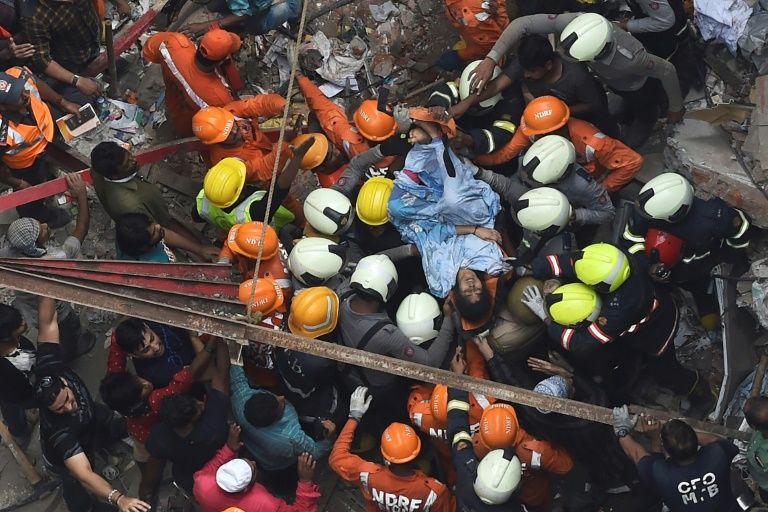 India’s National Disaster Response Force help rescue a survivor from a collapsed building in Mumbai. — AFP