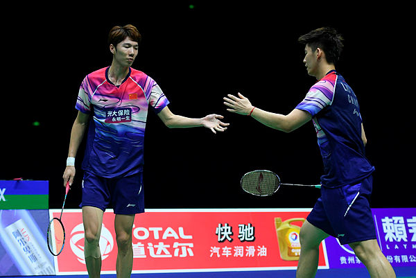 China’s Li Junhui and Liu Yuchen (R) react after winning a point against Thailand’s Tinn Isriyanet and Kittinupong Kedren during their men’s doubles semi-final match at the 2019 Sudirman Cup world badminton championships in Nanning in China’s on May 25, 2019. — AFP