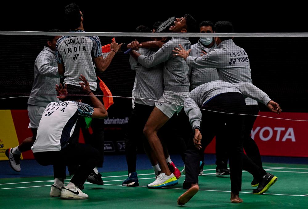 Members of India’s badminton team celebrate after India’s H.S. Prannoy wins against Denmark’s Rasmus Gemke during the semifinals of the Thomas and Uber Cup badminton tournament in Bangkok on May 13, 2022. AFPpix