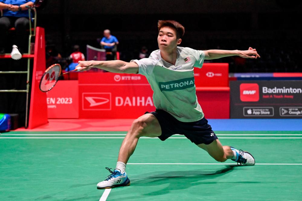 Ng Tze Yong of Malaysia hits a return against Loh Kean Yew of Singapore during their men’s singles match on the second day of the Japan Open badminton tournament in Tokyo on July 26, 2023. AFPPIX