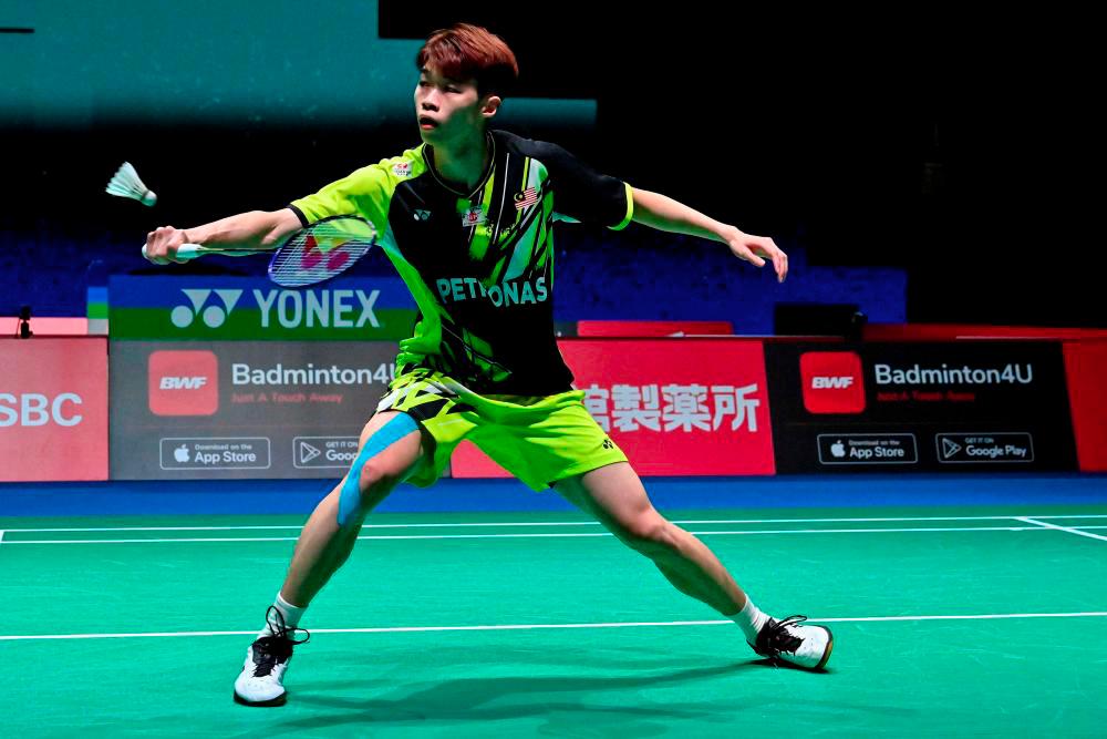 Ng Tze Yong of Malaysia hits a return against Chico Aura Dwi Wardoyo of Indonesia during their men’s singles match on day one of the Badminton World Championships in Tokyo on August 22, 2022. - AFPPIX