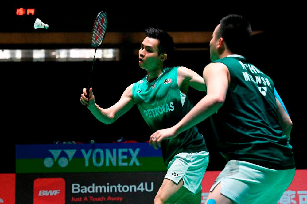 Aaron Chia (R) and Soh Wooi Yik of Malaysia play a shot against Mohammad Ahsan and Hendra Setiawan of Indonesia during their men’s doubles final match at the World Badminton Championships in Tokyo on August 28, 2022. AFPPIX