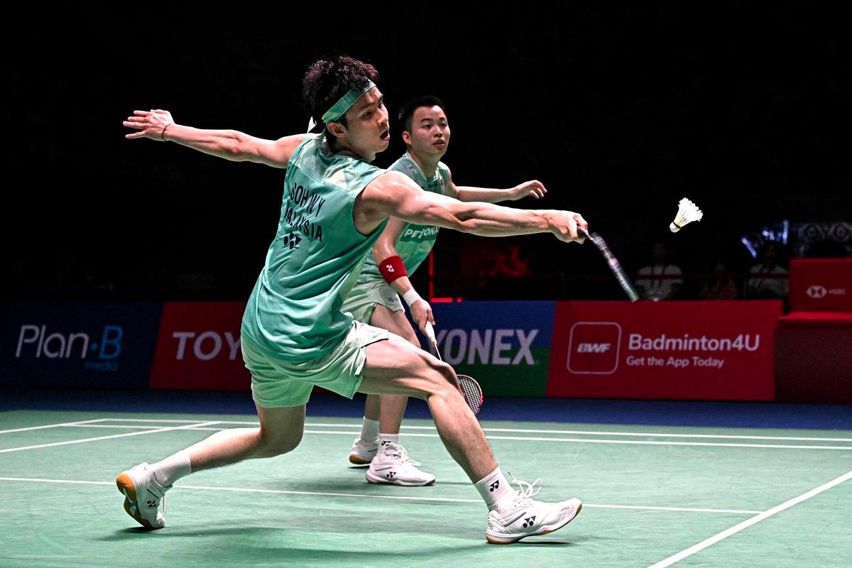 Soh Wooi Yik (front) hits a return as teammate Aaron Chia looks on during the men’s doubles final against Denmark’s William Kryger Boe and Christian Faust Kjaer at the 2025 Thailand Open badminton tournament in Bangkok on May 18, 2025. - AFPPIX