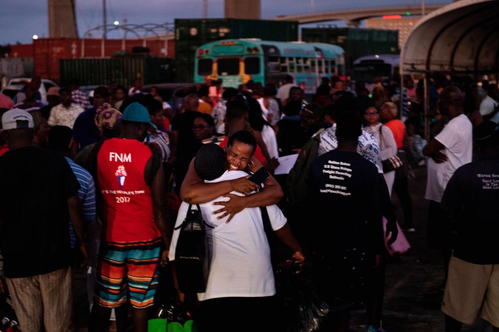 Refugees of Hurricane Dorian arrive at the Kendal GL Isaacs National Gym on September 6, 2019, in Nassau, New Providence. - AFP
