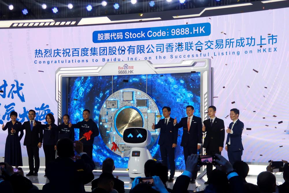 Li (fourth from right) at an event marking the company’s listing on Hong Kong Stock Exchange, at its headquarters in Beijing on Tuesday. – REUTERSPIX