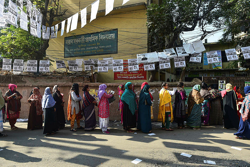 Bangladeshi voters wait in line outside a polling station in Dhaka on Dec 30, 2018. — AFP