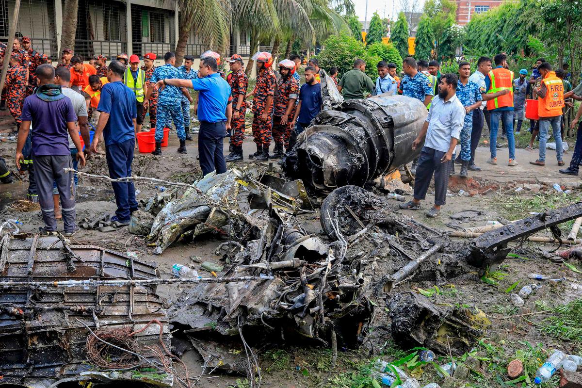 Bangladesh’s fire service and security personnel conduct a search and rescue operation after an Air Force training jet crashed into a school in Dhaka - AFPPix