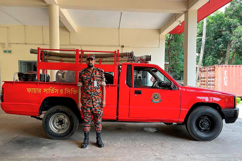 Rakibul Hasan Bappy poses for a picture at the fire station in Chittagong. - AFPPIX