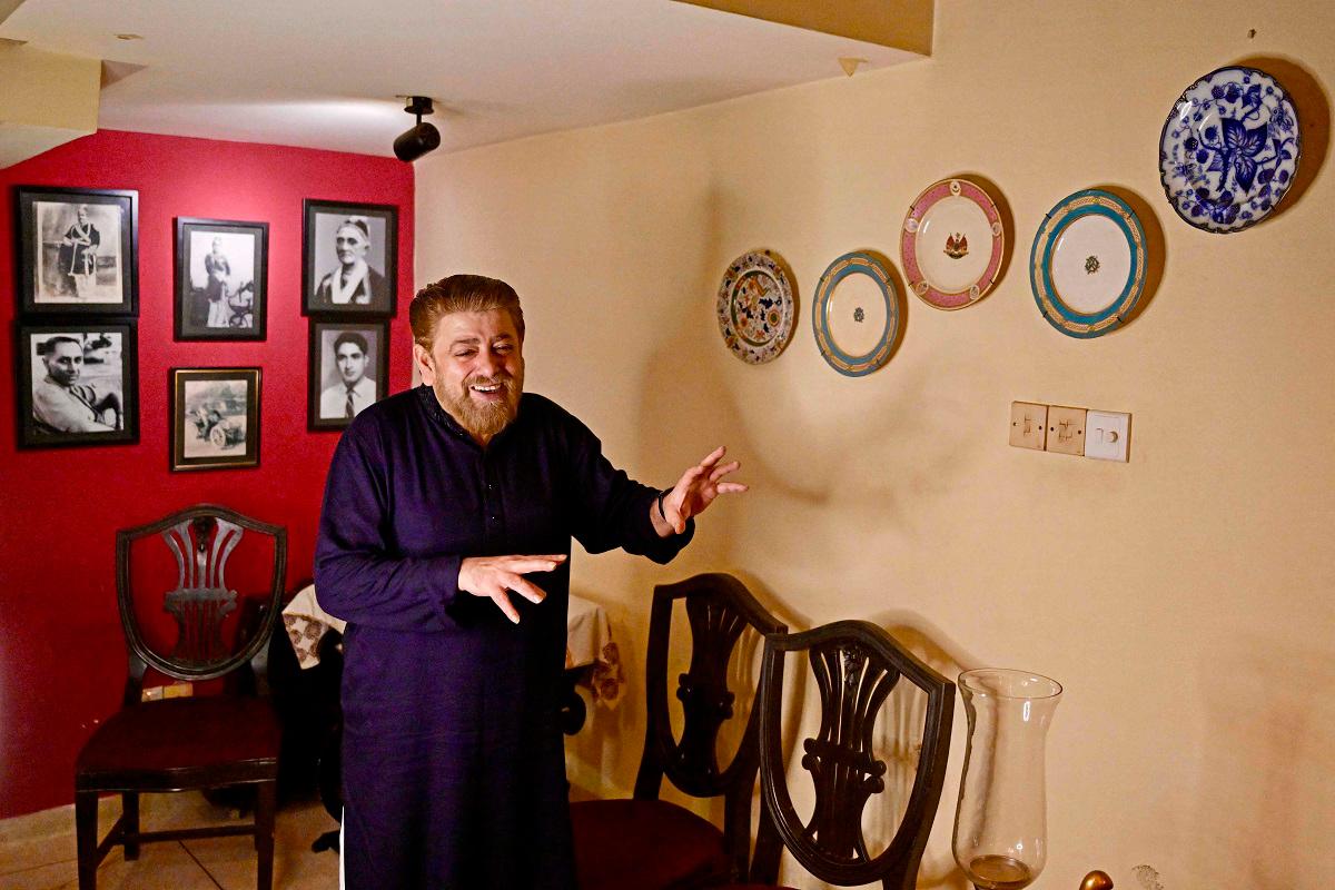 In this photograph taken on August 18, 2025, Khawaja Naim Murad, the great-grandson of Sir Salimullah Bahadur - the last prince or Nawab of Dhaka, shows plates bearing emblems of different Nawabs during an interview with AFP at his house in Dhaka. - Munir UZ ZAMAN / AFP