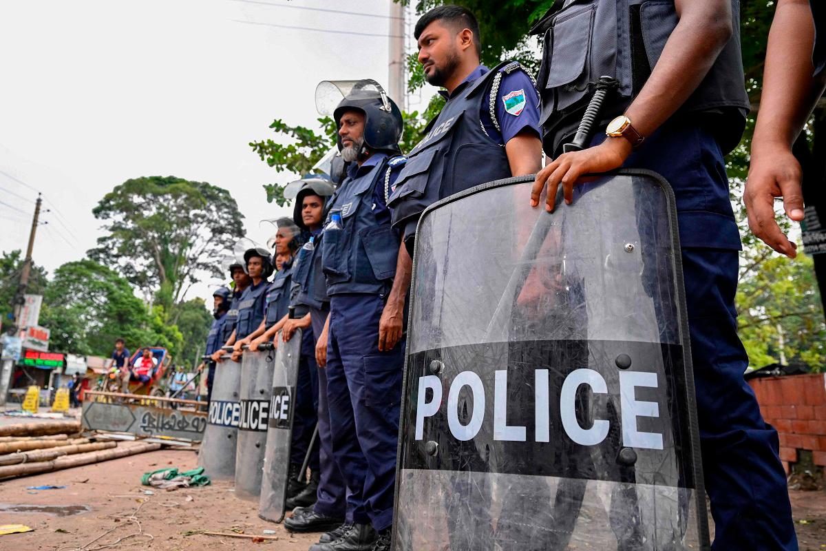 Anti-riot police personnel stand guard along a street in Gopalganj on July 17, 2025, a day after the clashes between supporters of the Awami League party and police during a rally by the National Citizens Party (NCP). At least three people were killed in Bangladesh on July 16 after clashes broke out between police and supporters of ousted prime minister Sheikh Hasina, authorities said. - Munir UZ ZAMAN / AFP