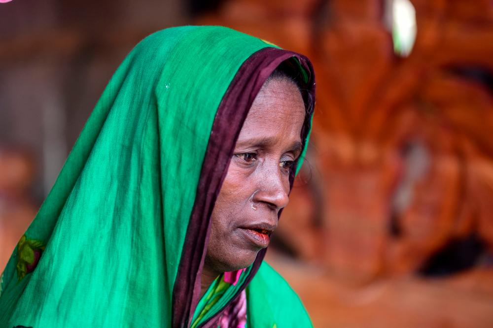 In this photograph taken on November 11, 2019, Bangladeshi mother-of-four Mosammat Rashida, whose husband was killed by a Bengal tiger a decade ago while he was collecting honey, speaks during an interview with AFP at her house in Shyamnagar. - AFP