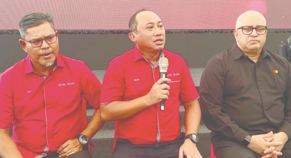 From left: Bank Islam head of deposit and cash management Mohd Noor Jab, Mizan and Mastercard Malaysia account management vice-president Devesh Kuwader at a press conference in conjunction with the launch of the Bank Islam Mastercard Debit Card-i.