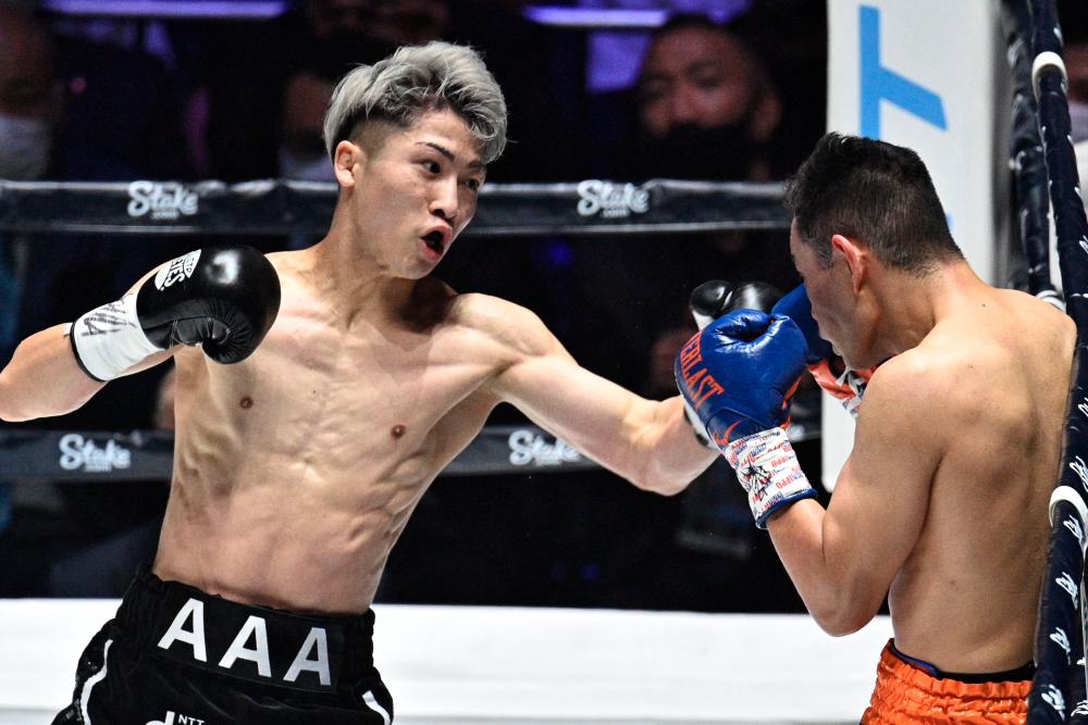 Japan's Naoya Inoue (left) fights against Philippines' Nonito Donaire during their Bantamweight unification match at Saitama Super Arena. - AFPPIX