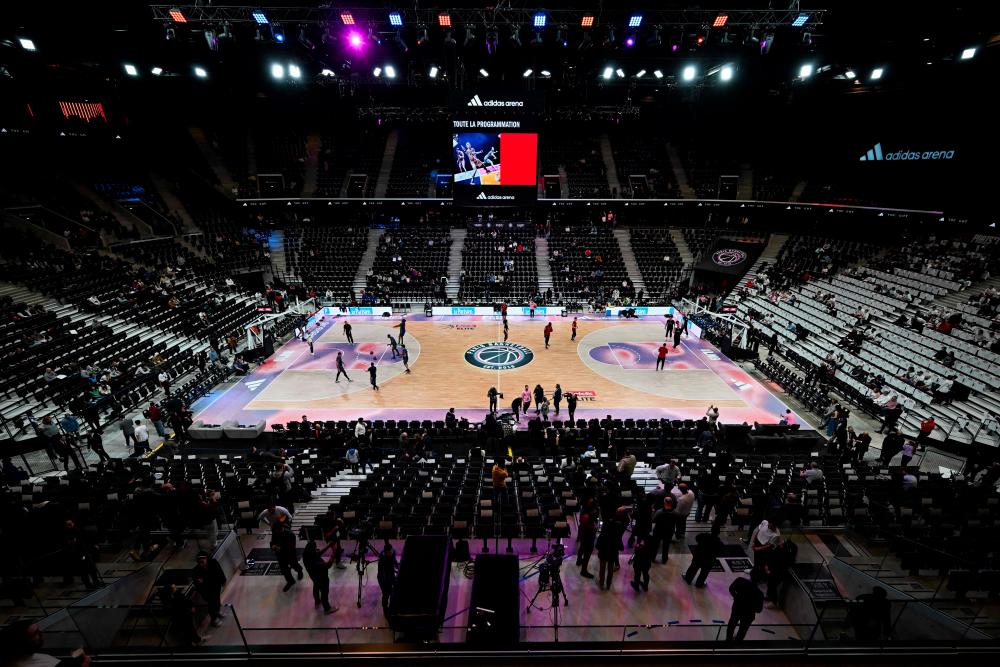 Players' warm up ahead of the French Elite basketball match between Paris and Saint-Quentin at the Arena Porte de La Chapelle in Paris, on February 11, 2024. (Photo by MIGUEL MEDINA / AFP)