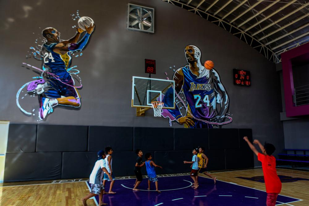 Children play basketball at the House of Kobe gym, built in honour of former Los Angeles Lakers basketball player Kobe Bryant's 2016 visit to the Philippines, in Manila on January 27, 2020. - AFP