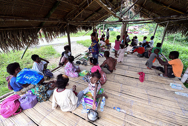 This picture taken on June 11 shows members of the Orang Asli community, resting in a “pondok” at Kampung Kuala Koh after receiving treatment from the Gua Musang Health Department.