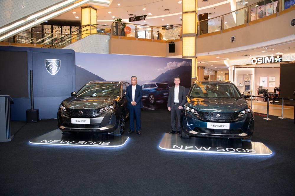 Yeoh (left) posing alongside Stellantis’ Asean &amp; general distributors senior vice president, Christophe Musy at the launch of Peugeot 3008 and Peugeot 5008.