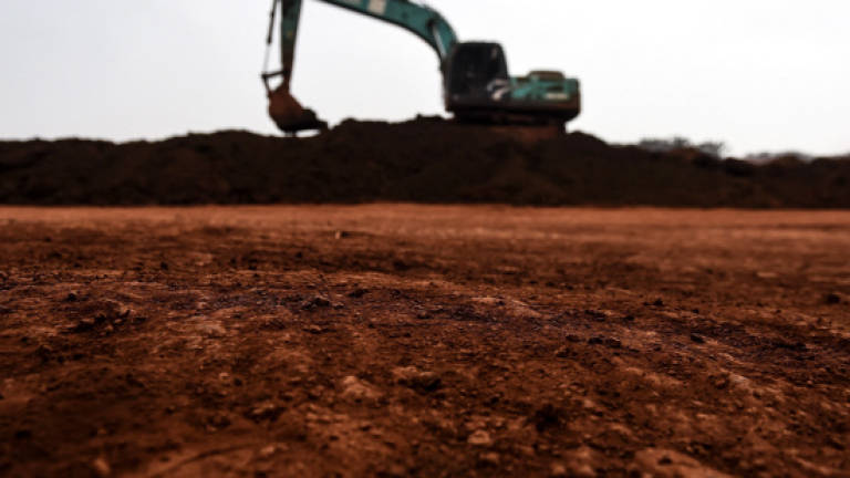 In this picture taken Oct 13, 2015, an excavator is seen at bauxite storage site in Bukit Goh, Pahang. — AFP
