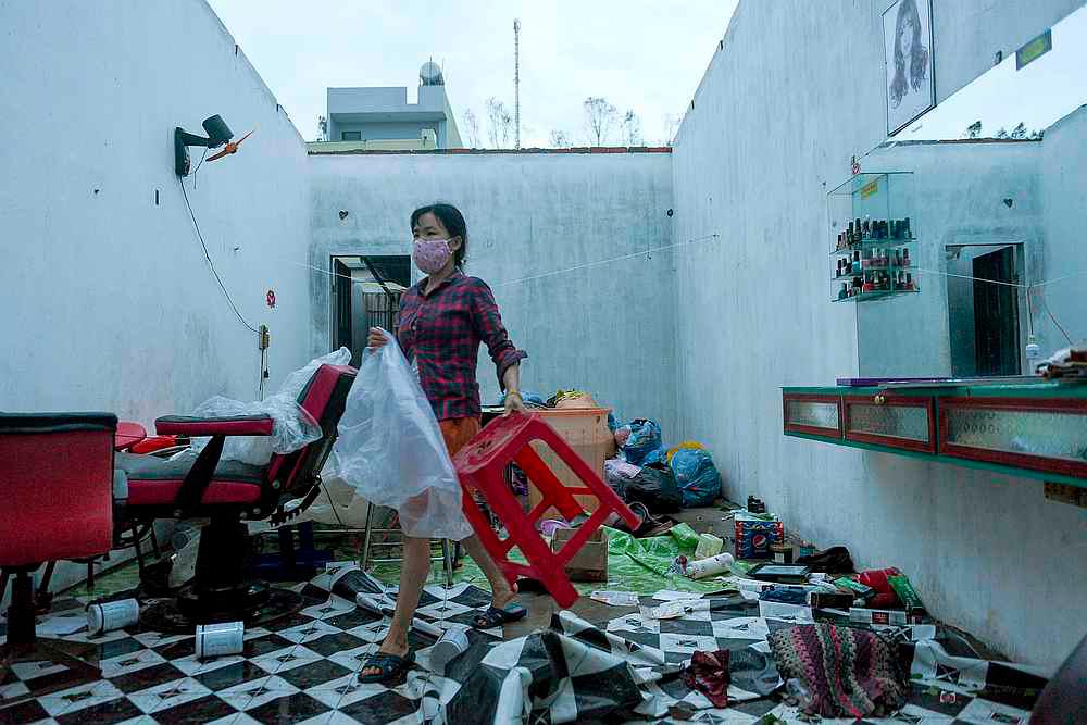A woman works in a barbershop damaged by the Typhoon Molave in Binh Chau village, Quang Ngai province, Vietnam October 28, 2020. — Reuters