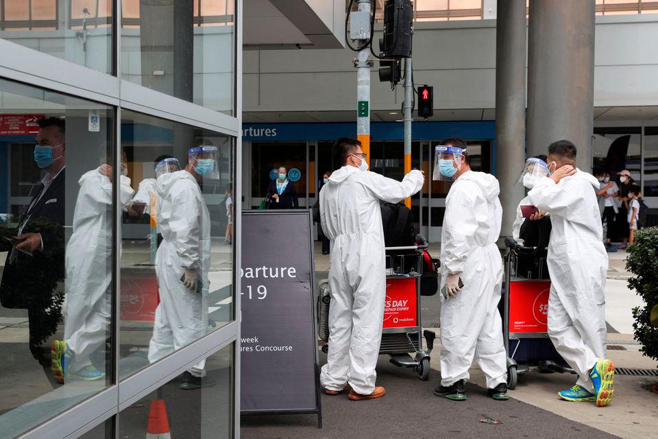 Travellers wear personal protective equipment outside the international terminal at Sydney Airport, as countries react to the new coronavirus Omicron variant amid the coronavirus disease (COVID-19) pandemic, in Sydney, Australia, November 29, 2021. REUTERSPIX