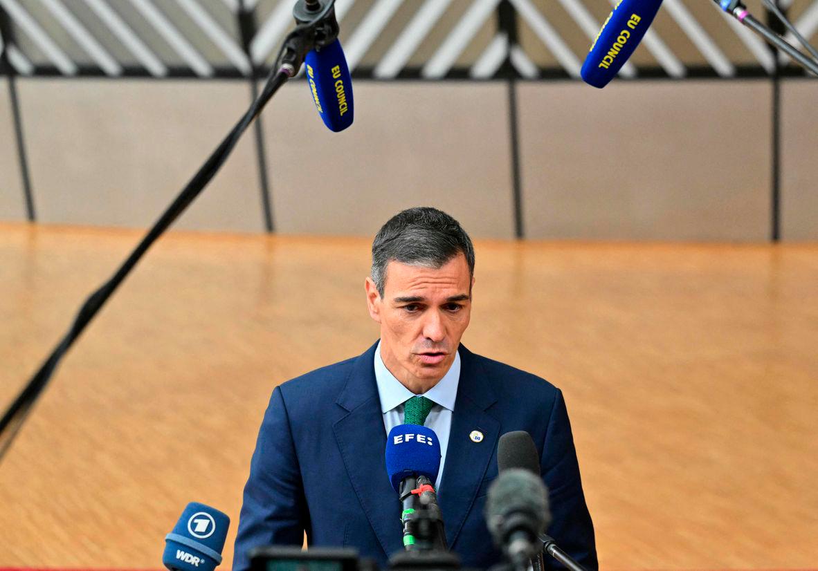 Spain’s Prime Minister Pedro Sanchez speaks to the press as he arrives to attend the European Council in Brussels on June 26, 2025. (Photo by NICOLAS TUCAT / AFP)