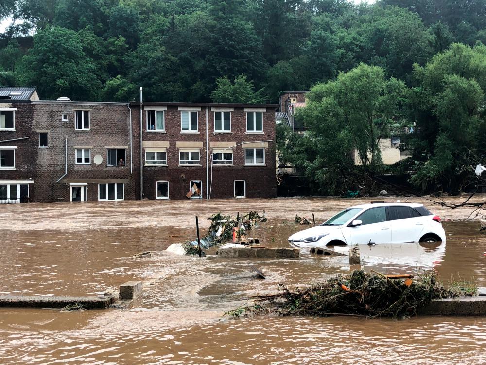 A partially-submerged car is seen on a flooded street in Pepinster, Belgium July 15, 2021. — Reuters