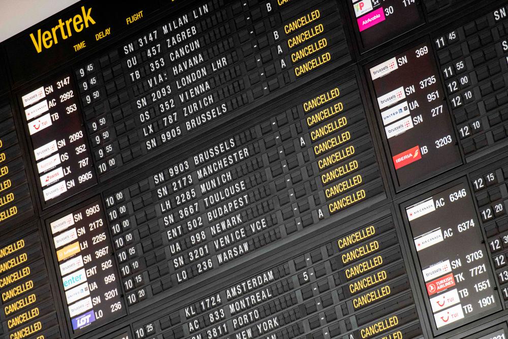 A picture shows a departures board displaying all flights being cancelled during a strike in several companies and security personnel to defend purchasing power and demand an amendment to the 1996 wage standards law that regulates wage developments in Belgium, at Brussels Airport in Zaventem, on June 20, 2022. AFPPIX