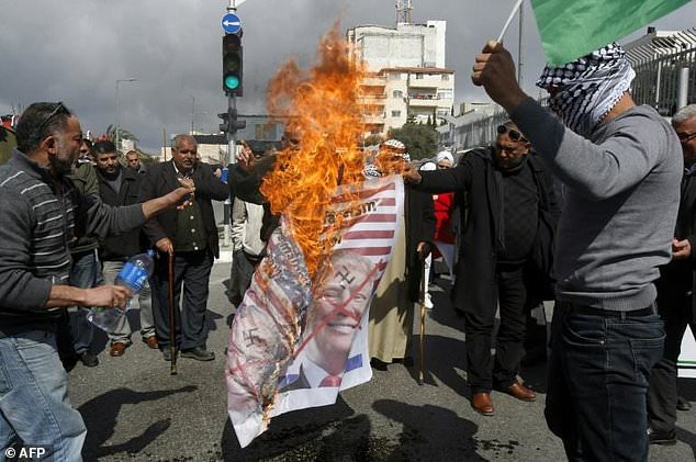 Palestinians burn images of Israeli Prime Minister Benjamin Netanyahu and US President Donald Trump in protest at Israel’s decision to withhold Palestinian tax receipts that has helped trigger a suffocating financial crisis — AFP