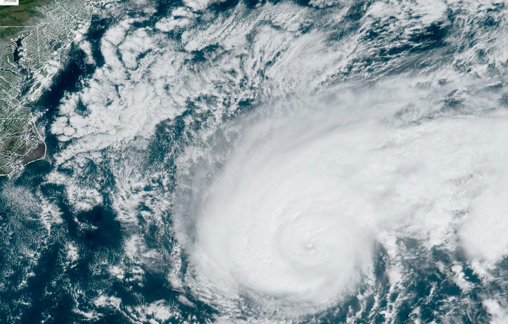 This satellite image obtained from NOAA/RAMMB, shows Tropical Storm Humberto at 15:10 UTC on September 18, 2019 as it moves off the US east coast in the Atlantic Ocean. — AFP