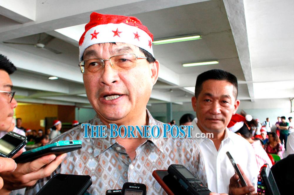 Baru speaks to journalists as Batu Lintang assemblyman See Chee How looks on.