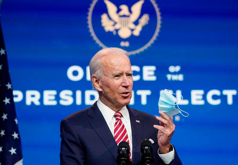 U.S. President-elect Joe Biden holds up a face mask as he speaks about the U.S. economy following a briefing with economic advisers in Wilmington, Delaware, U.S., November 16, 2020. — Reuters