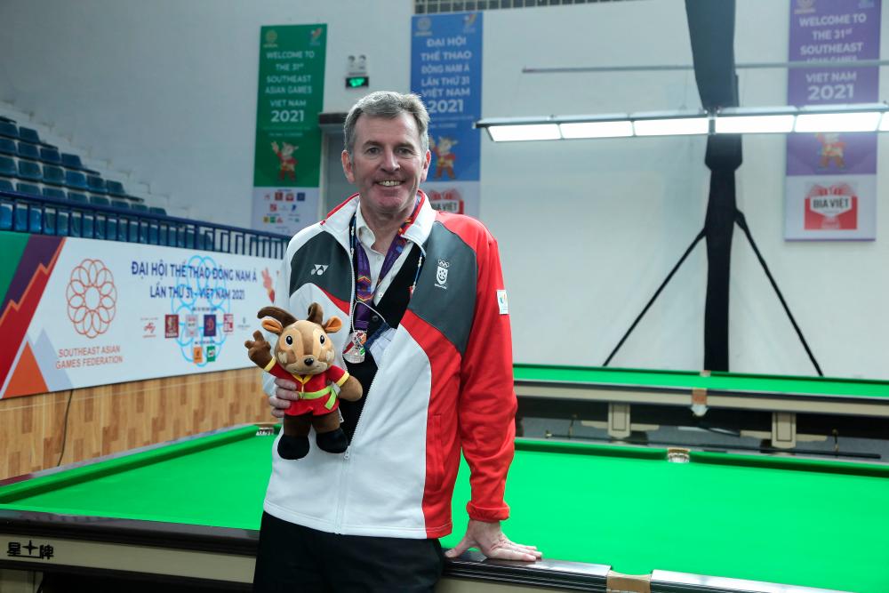 Singaporean billiard player Peter Gilchrist poses with his silver medal after the final of the English billiards men’s singles event at the 31st Southeast Asian Games (SEA Games) in Hanoi on May 17, 2022. AFPPIX