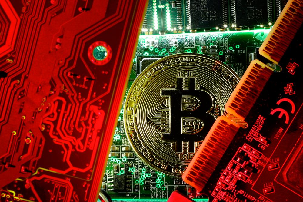 A copy of bitcoin standing on PC motherboard is seen in this illustration picture. REUTERSPIX