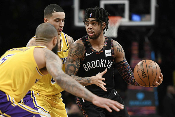 D’Angelo Russell #1 of the Brooklyn Nets dribbles around Los Angeles Lakers defense during the third quarter of the game at Barclays Center on Dec 18, 2018 in New York City. — AFP