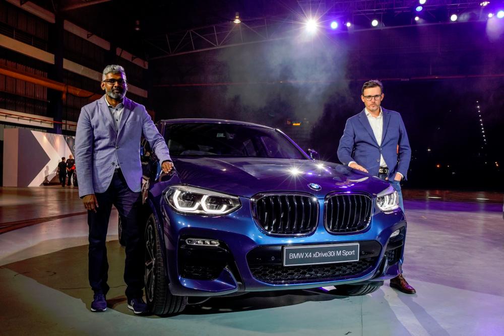 $!Hoelzl (right) and BMW Group Malaysia head of corporate communications Sashi Ambi with the second-generation BMW X4.