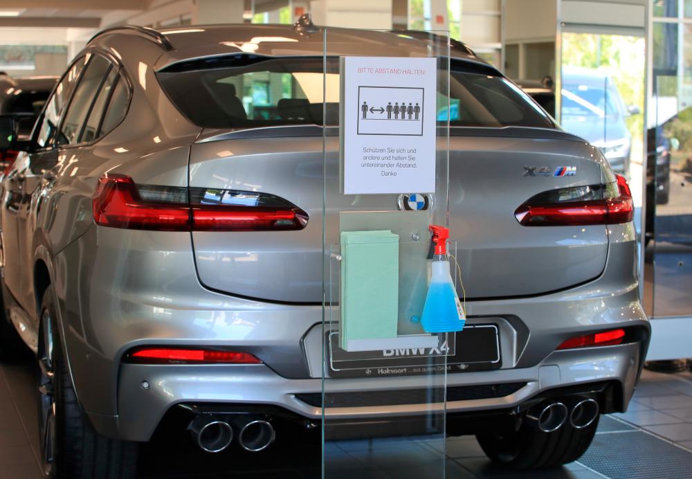 Disinfectant and distancing rules are seen in the sales room of the BMW dealer Hakvoort in Koenigswinter, Germany, in April. – REUTERSPIX