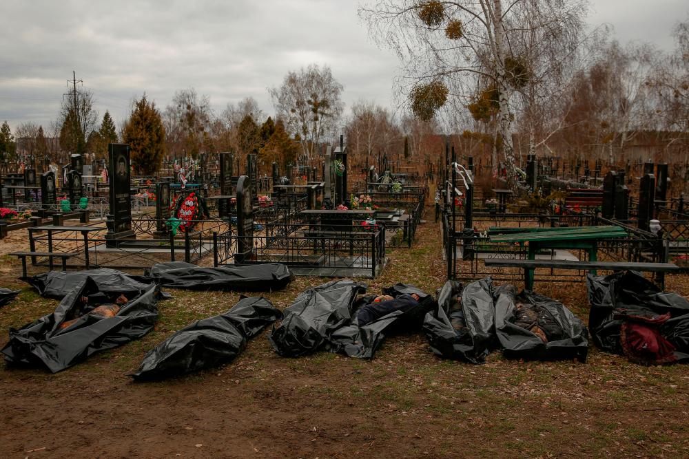 Bodies of civilians, collected from streets to local cemetery, are seen as Russia's attack on Ukraine continues, in the town of Bucha/REUTERSPix