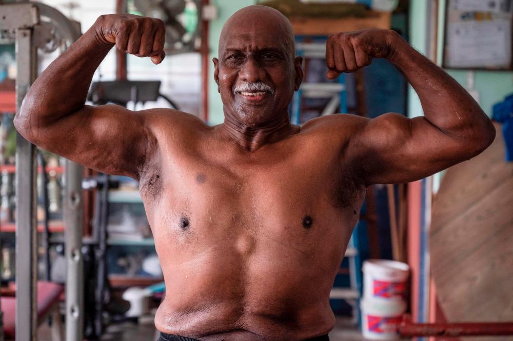 This picture taken on March 18, 2021 shows bodybuilder A. Arokiasamy posing for pictures after training at his gymnasium in Teluk Intan in Malaysia’s Perak state. - AFP