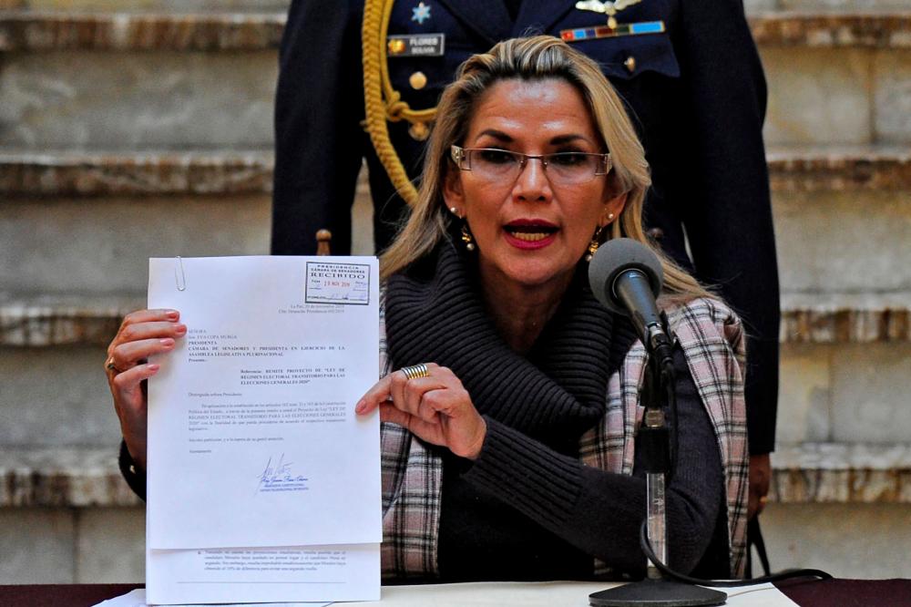 Bolivian interim President Jeanine Anez shows a document as she presents a bill on the Transition Electoral Regime for the 2020 general elections at Quemado presidential palace in La Paz on Nov 20. — AFP