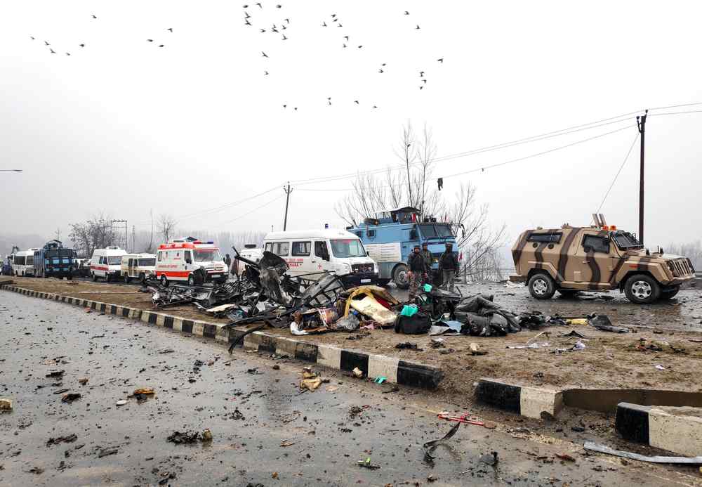 Indian soldiers examine the debris after an explosion in Lethpora in south Kashmir’s Pulwama district, on February 14, 2019. — Reuters