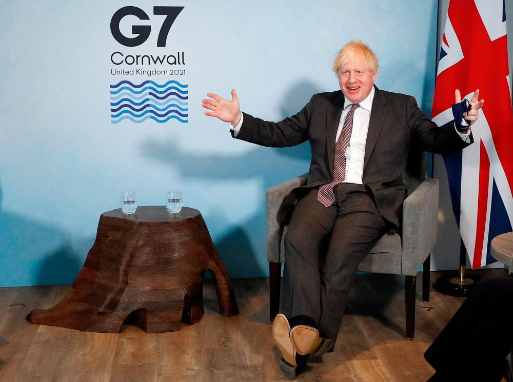 Britain's Prime Minister Boris Johnson reacts as he meets with European Commission President Ursula von der Leyen and European Council President Charles Michel during the G7 summit in Carbis Bay, Cornwall, Britain, June 12, 2021. — Reuters