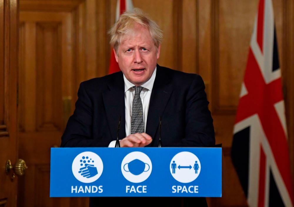 Britain's Prime Minister Boris Johnson speaks during a virtual press conference inside 10 Downing Street in central London on October 31, 2020 to announce new lockdown restrictions in an effort to curb rising infections of the novel coronavirus. — AFP