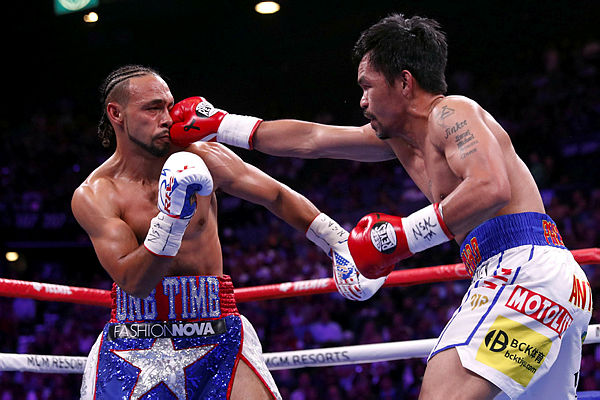 Manny Pacquiao (right) lands a punch on Keith Thurman during their WBA welterweight title fight at the MGM Grand Garden Arena on July 20, 2019 in Las Vegas, Nevada. — AFP