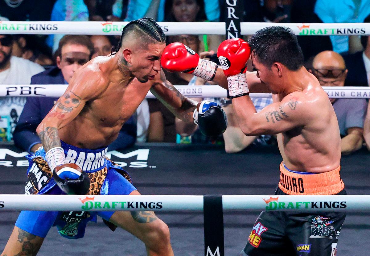 Manny Pacquiao (R) throws a right at Mario Barrios in the 12th round of their WBC welterweight title fight at MGM Grand Garden Arena on July 19, 2025 in Las Vegas, Nevada. The fight was declared a majority draw and Barrios retained his title. - Ethan Miller/Getty Images/AFP