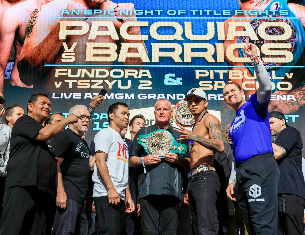 Trainers Buboy Fernandez and Freddie Roach, Manny Pacquiao, TGB Promotions President Tom Brown, WBC welterweight champion Mario Barrios and his head coach Bob Santos pose during a ceremonial weigh-in at MGM Grand Garden Arena - Ethan Miller/Getty Images/AFP