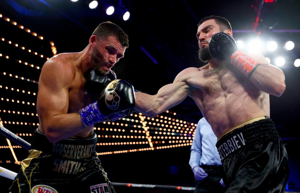 NEW YORK, NEW YORK - JUNE 18: Artur Beterbiev hits Joe Smith Jr during the light heavyweight title bout at The Hulu Theater at Madison Square Garden on June 18, 2022 in New York City. Beterbiev won after the fight was stopped in the second round. AFPPIX