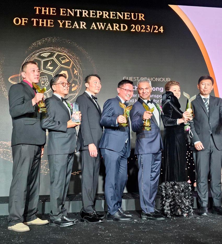 Frank (4th from left) on stage with the other winners after receiving his trophy.