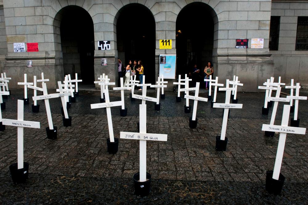 (FILES) In this file photo taken on April 8, 2013, crosses are seen in front of the School of Law of the University of Sao Paulo (USP) in homage to the inmates dead at the Carandiru Penitentiary massacre in Sao Paulo, Brazil. Brazil's outgoing president, Jair Bolsonaro, on December 23, 2022, pardoned security force agents convicted of crimes committed more than 30 years ago, which according to legal experts, applies to those responsible for the 1992 Carandiru prison massacre. AFPPIX